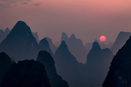 sun rising over Chinese mountains